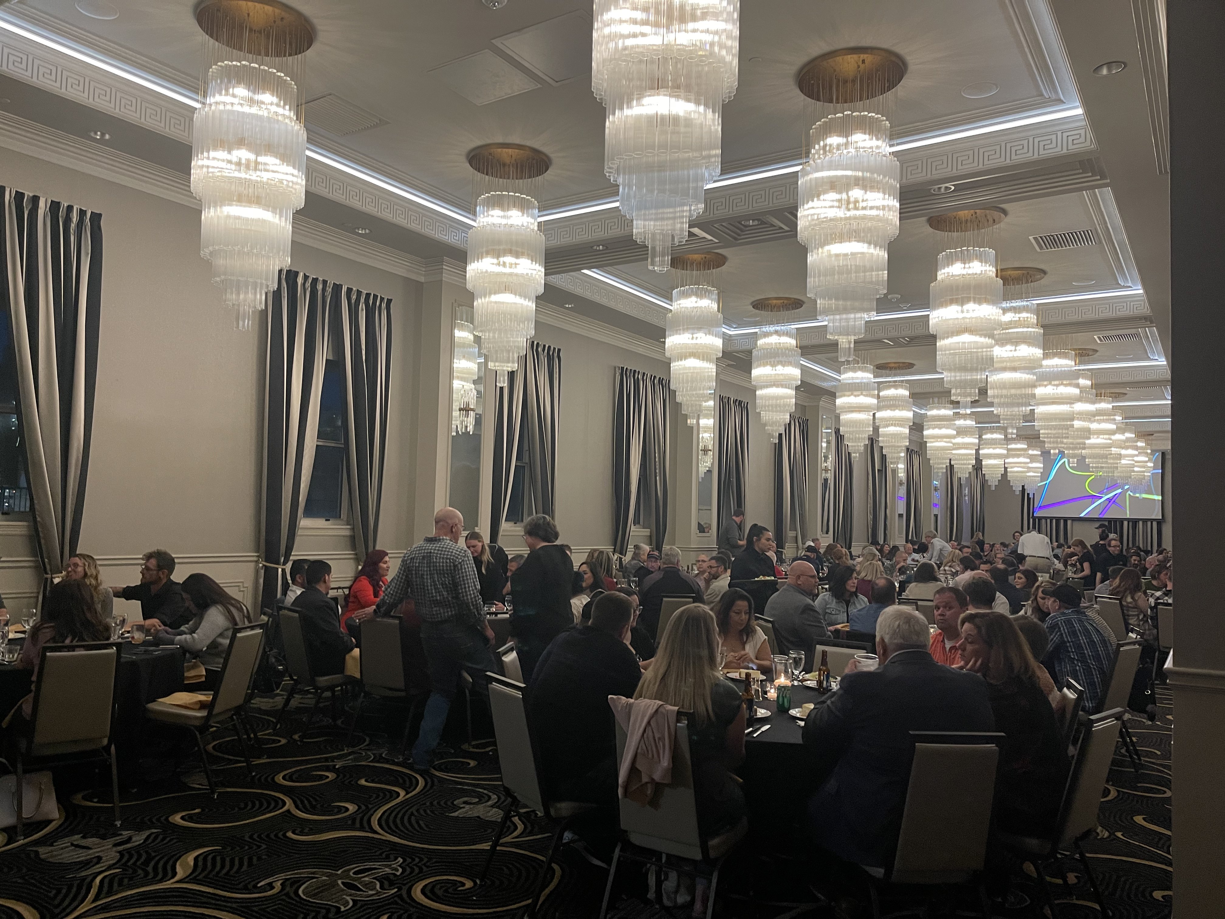 Full ballroom event with crystal chandeliers